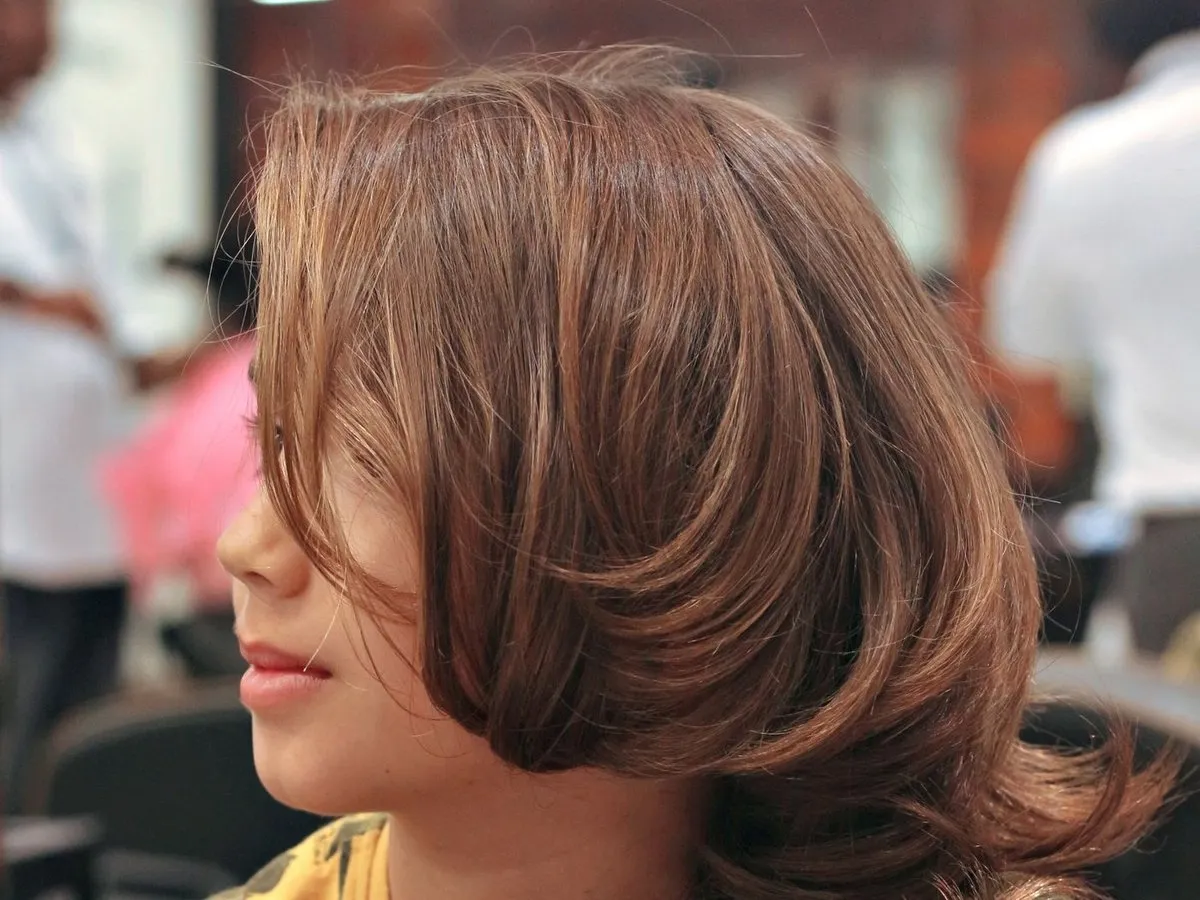 A woman with a freshly cut, layered hairstyle